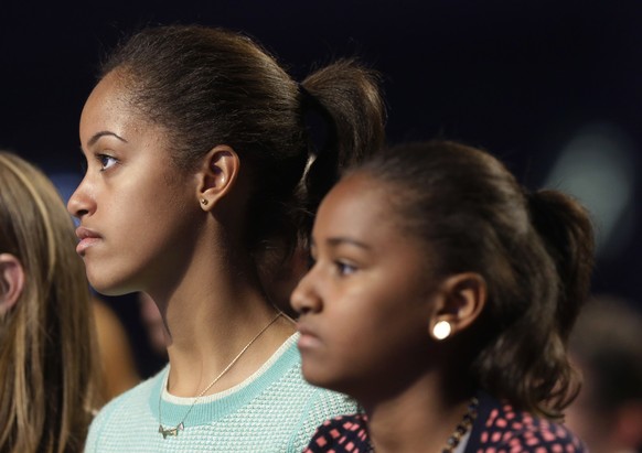 FILE - In this Jan. 19, 2013, file photo, Malia Obama, left, and her sister, Sasha Obama, right, listen during the Kids&#039; Inaugural: Our Children. Our Future.&quot; event in Washington. Malia is a ...
