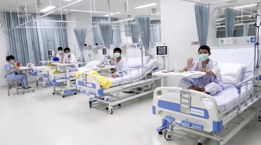 This image made from a video taken on July 13, 2018 and released by Chiang Rai Prachanukroh Hospital, shows some of the 12 boys rescued from the flooded cave, in their hospital room at Chiang Rai Prac ...