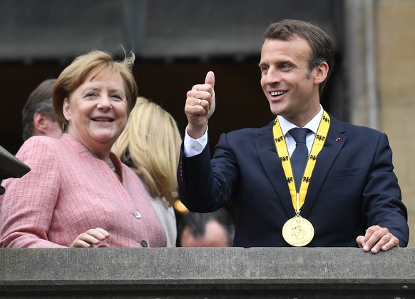 German Chancellor Angela Merkel and French President Emmanuel Macron stand on the town hall balcony on occasion of the Charlemagne Prize awarding in Aachen, Germany, Thursday, May 10, 2018. (AP Photo/ ...