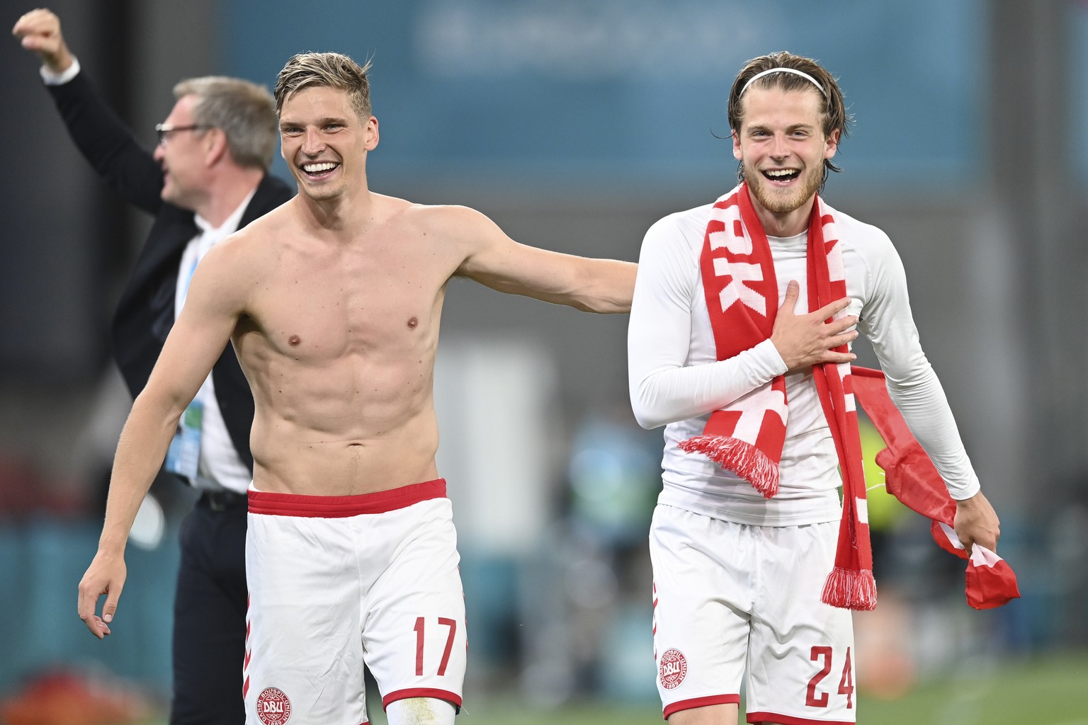 Denmark&#039;s Jens Stryger Larsen, left, and Denmark&#039;s Mathias Jensen celebrate after the Euro 2020 soccer championship group B match between Russia and Denmark at the Parken stadium in Copenhag ...