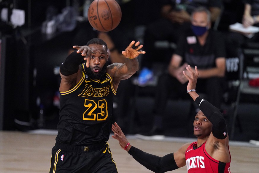 Los Angeles Lakers&#039; LeBron James (23) passes the ball against Houston Rockets&#039; Russell Westbrook (0) during the second half of an NBA conference semifinal playoff basketball game Sunday, Sep ...