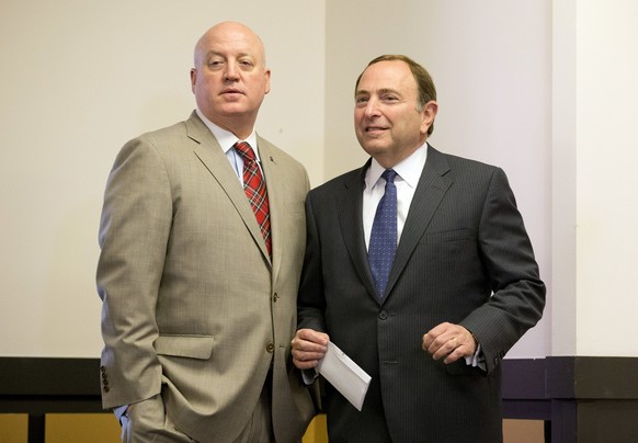 FILE - In this Dec. 9, 2014, file photo, NHL hockey commissioner Gary Bettman, right, and deputy commissioner Bill Daly pause before starting a news conference after attending an NHL owners meeting in ...