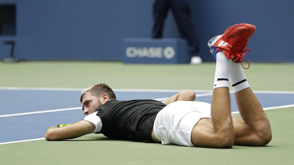 Benoit Paire, of France, lays on the court during a match against Roger Federer, of Switzerland, in the second round of the U.S. Open tennis tournament, Thursday, Aug. 30, 2018, in New York. (AP Photo ...