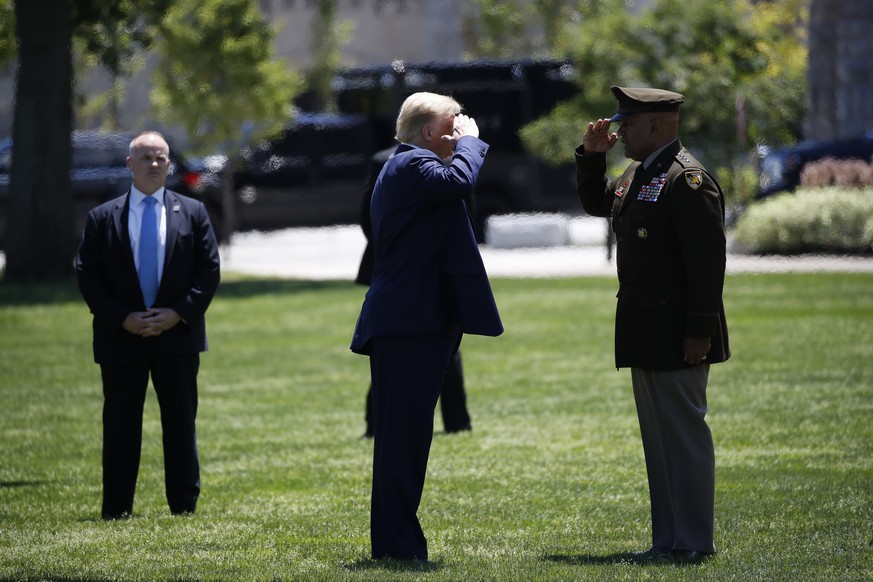 President Donald Trump salutes Superintendent of the United States Military Academy Lt. Gen. Darryl Williams before departing on Marine One after speaking to the Class of 2020 at a commencement ceremo ...
