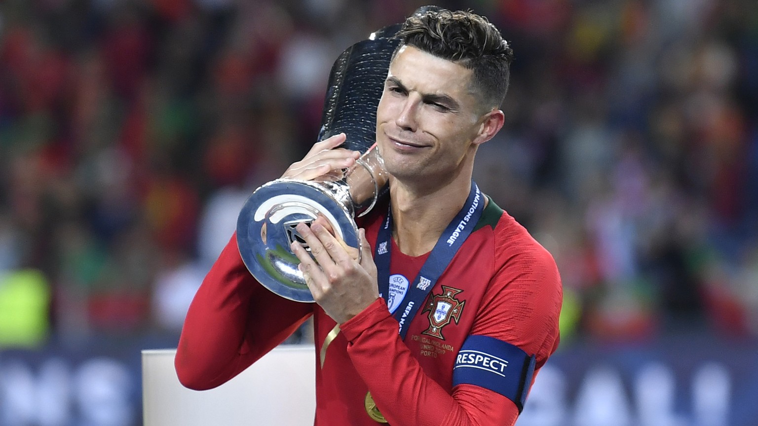 Portugal&#039;s Cristiano Ronaldo gestures as holds the trophy while he celebrates winning the UEFA Nations League final soccer match between Portugal and Netherlands at the Dragao stadium in Porto, P ...