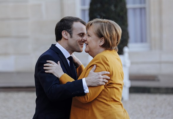French President Emmanuel Macron, left, greets German Chancellor Angela Merkel prior to their meeting at the Elysee Palace in Paris, Wednesday, Feb. 27, 2019. (AP Photo/Kamil Zihnioglu)