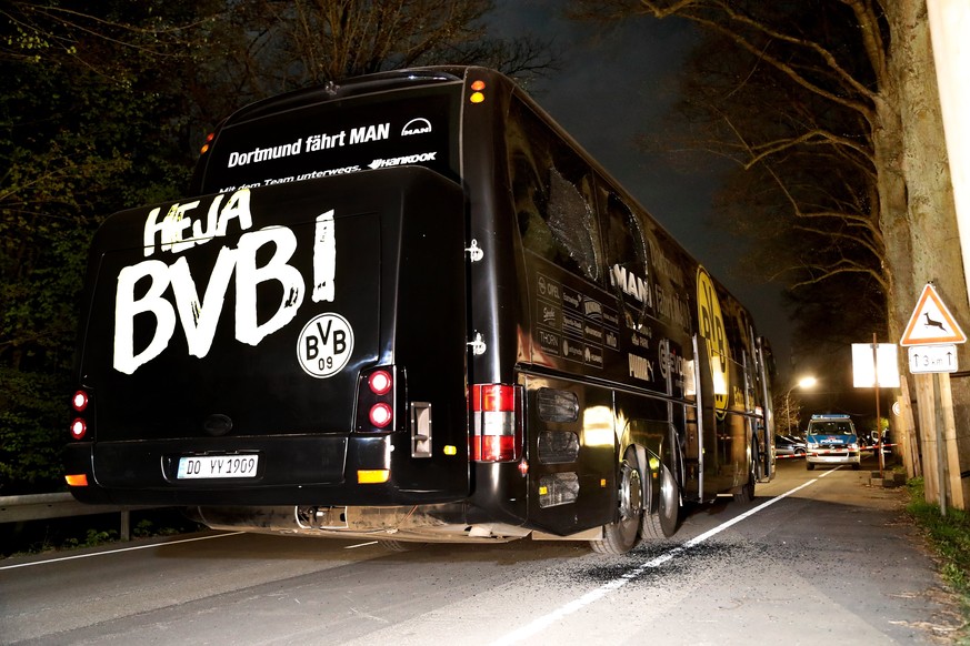 epa05903584 Team bus of Borussia Dortmund is seen on a street after it was hit by three explosions in Dortmund, Germany, 11 April 2017. According to reports, Borussia Dortmund&#039;s team bus was dama ...
