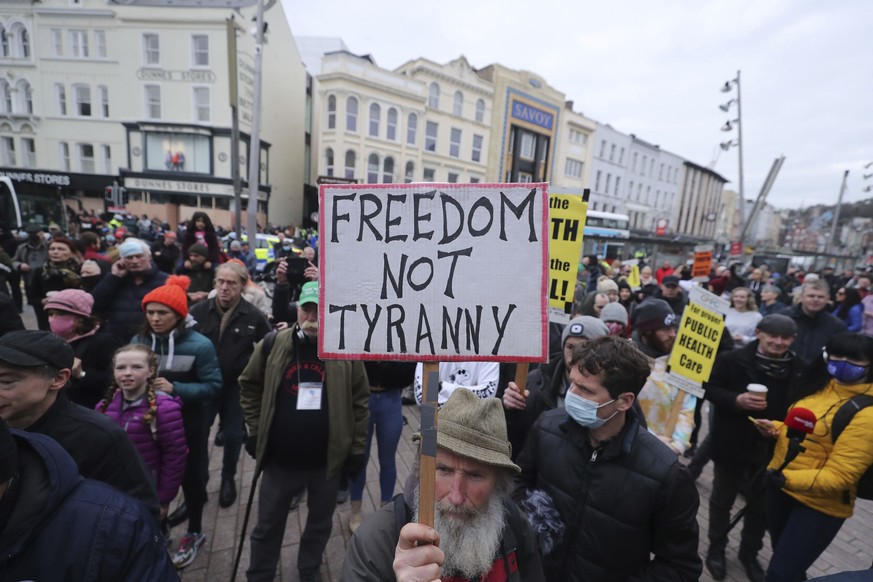 People take part in a demonstration against coronavirus lockdown restrictions organised by the People&#039;s Convention, in Cork city centre, Ireland, Saturday March 6, 2021. (Niall Carson/PA via AP)