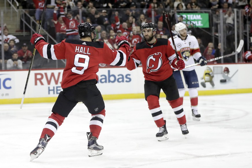 New Jersey Devils left wing Taylor Hall (9) celebrates his goal against the Florida Panthers with teammate Kyle Palmieri, right, during the second period of an NHL hockey game, Saturday, Oct. 27, 2018 ...