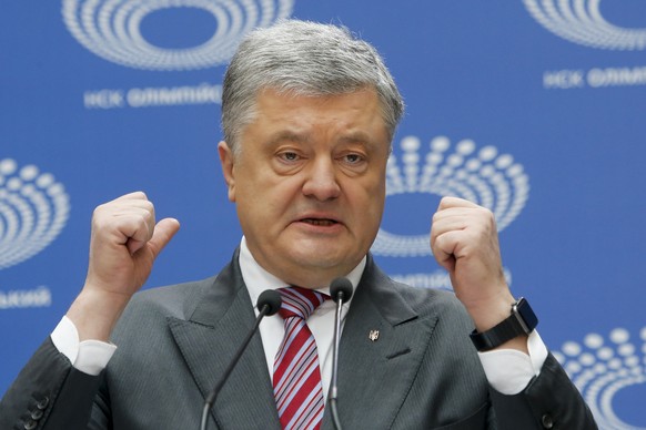 Ukrainian President Petro Poroshenko gestures while answering to a journalist&#039;s question ahead of the presidential elections on April 21, at the Olympic stadium in Kiev, Ukraine, Sunday, April 14 ...